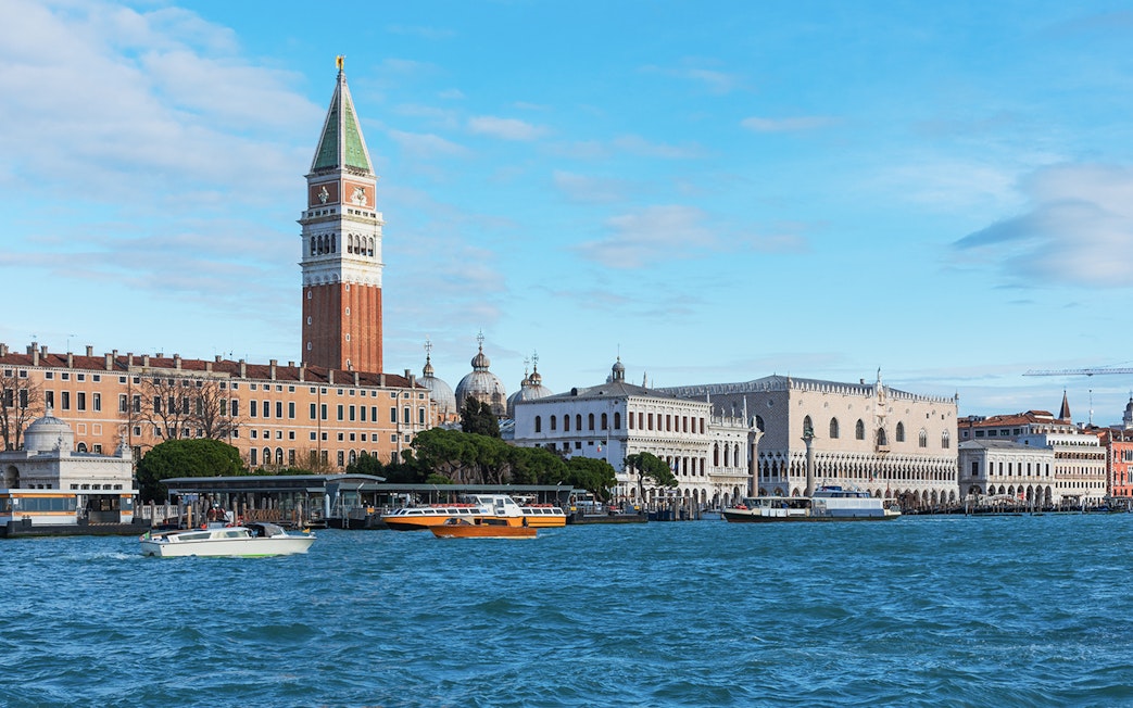 San Marco Venice view from a boat with St. Mark's Campanile and Doge's Palace.