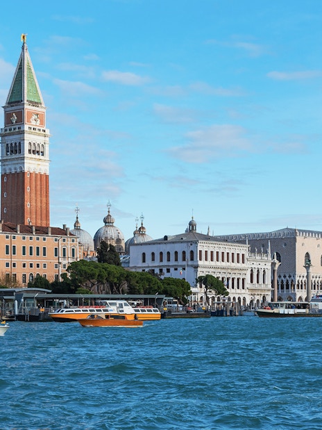 San Marco Venice view from a boat with St. Mark's Campanile and Doge's Palace.