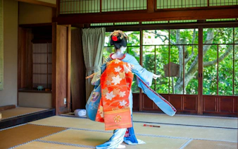 Geisha performing traditional dance in a Kyoto Zen temple.