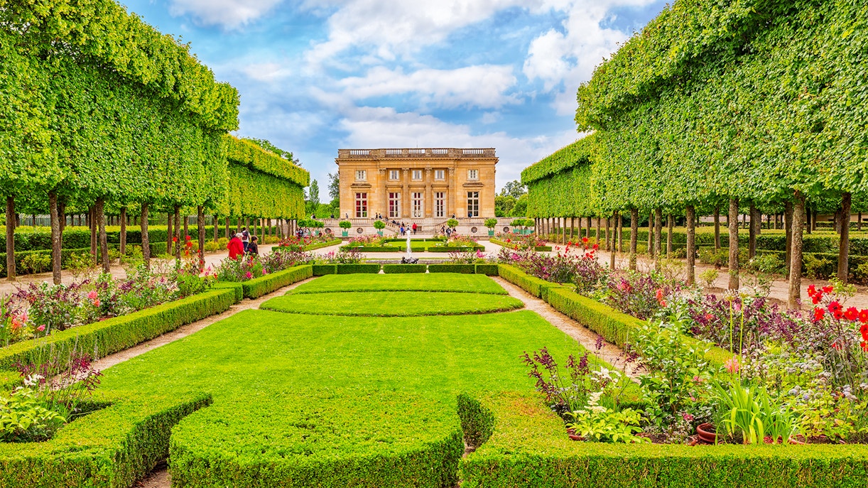 Formal gardens leading to the Petit Trianon at Versailles, France.