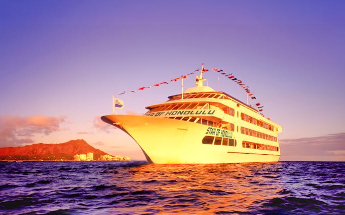 Cruise ship sailing near Diamond Head, Honolulu at sunset.