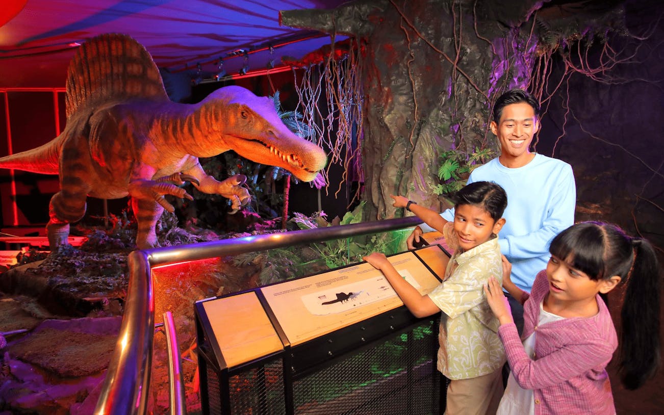 Visitors observing dinosaur exhibit at Petrosains The Discovery Centre.