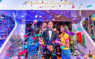 Tourists celebrating with Pit Bull wax statue at Madame Tussauds Orlando.