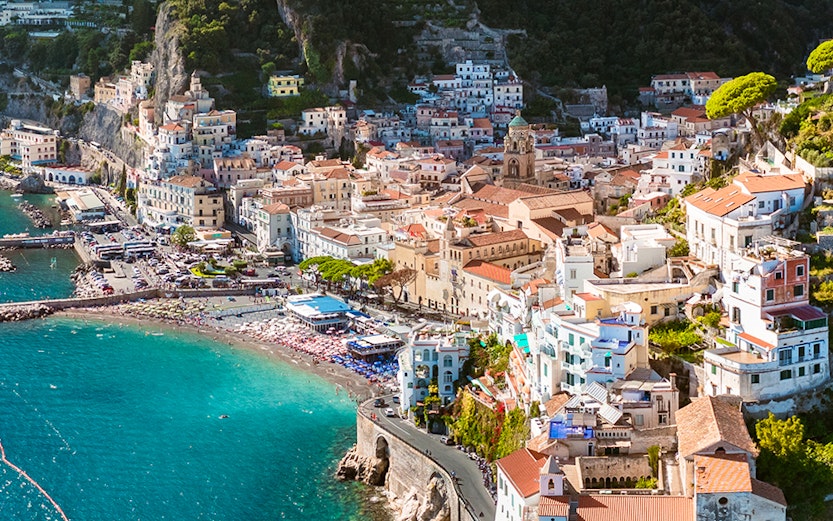 Aerial view of Amalfi Coast with colorful buildings and coastline, Italy.