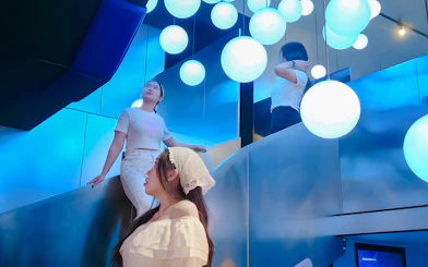 Visitors exploring the illuminated Space & Time Cube exhibit in Bangkok.