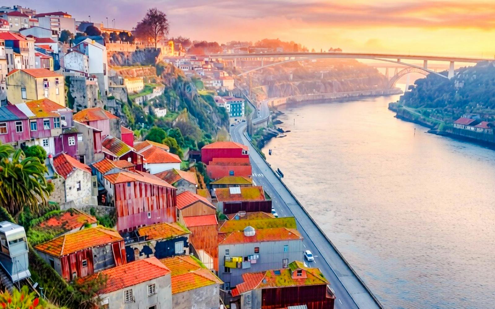 Sunlit view of Ribeira neighborhood and Douro River in Porto, Portugal.