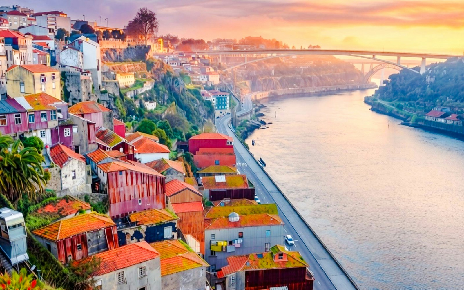 Sunlit view of Ribeira neighborhood and Douro River in Porto, Portugal.