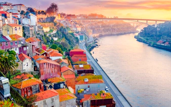 Sunlit view of Ribeira neighborhood and Douro River in Porto, Portugal.