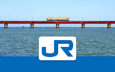 Train crossing a bridge over water in the Kansai-Hiroshima area, Japan.