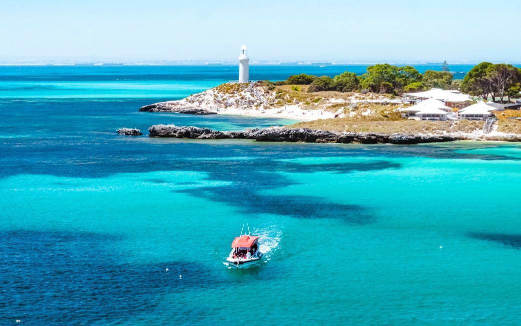 Snorkel tour boat near Rottnest Island lighthouse, turquoise waters, Perth/Fremantle.