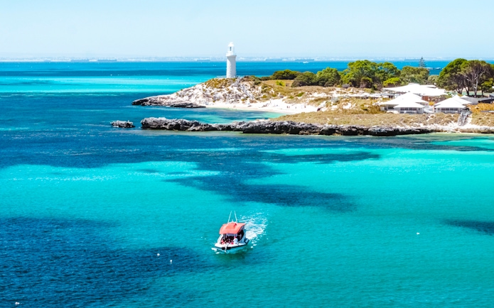 Snorkel tour boat near Rottnest Island lighthouse, turquoise waters, Perth/Fremantle.