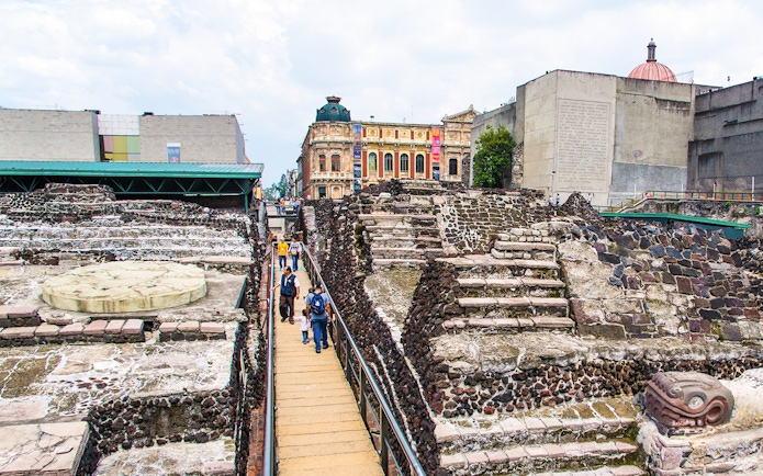 Visitors walking through Templo Mayor ruins in Mexico City.
