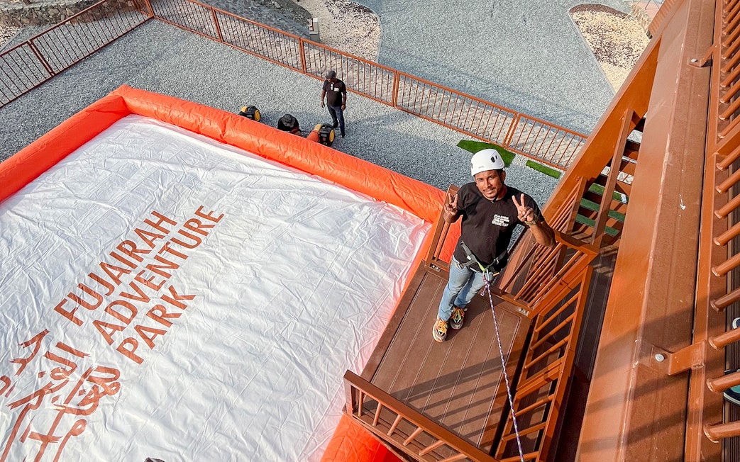 Man preparing for a jump at Fujairah Adventure Park with safety gear.