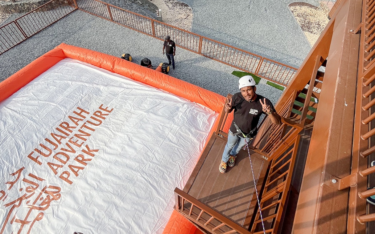 Man preparing for a jump at Fujairah Adventure Park with safety gear.