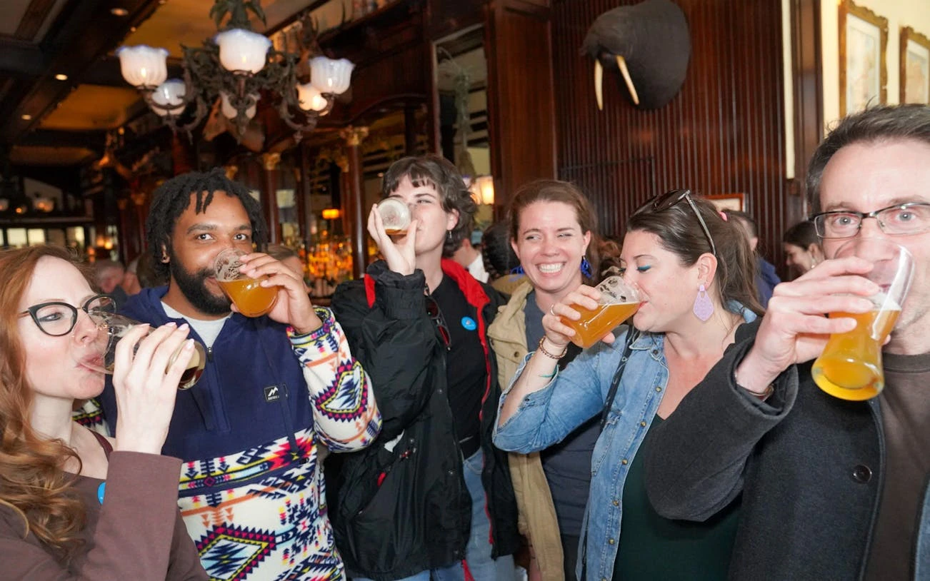 Group enjoying drinks at a lively pub during an Insider's Pub Crawl.
