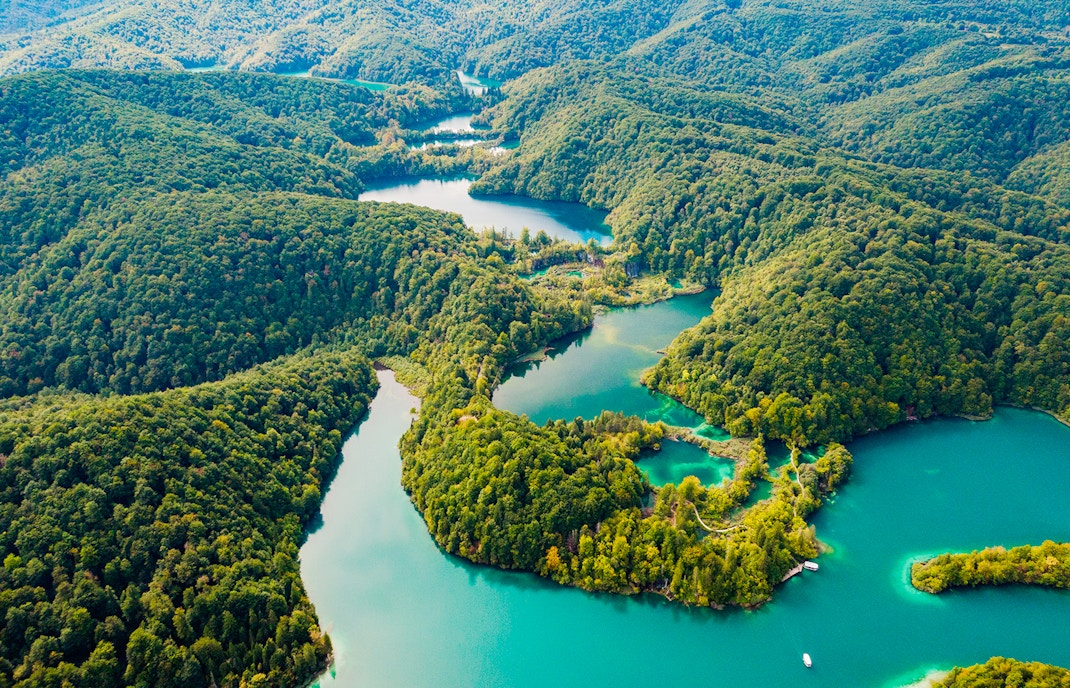 Aerial view of waterfalls and lush greenery at Plitvice Lakes, Croatia.