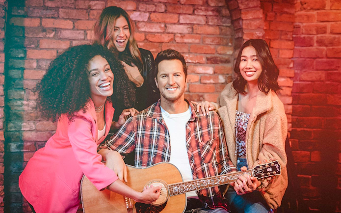 Guests interacting with a wax figure holding a guitar at Madame Tussauds Nashville.