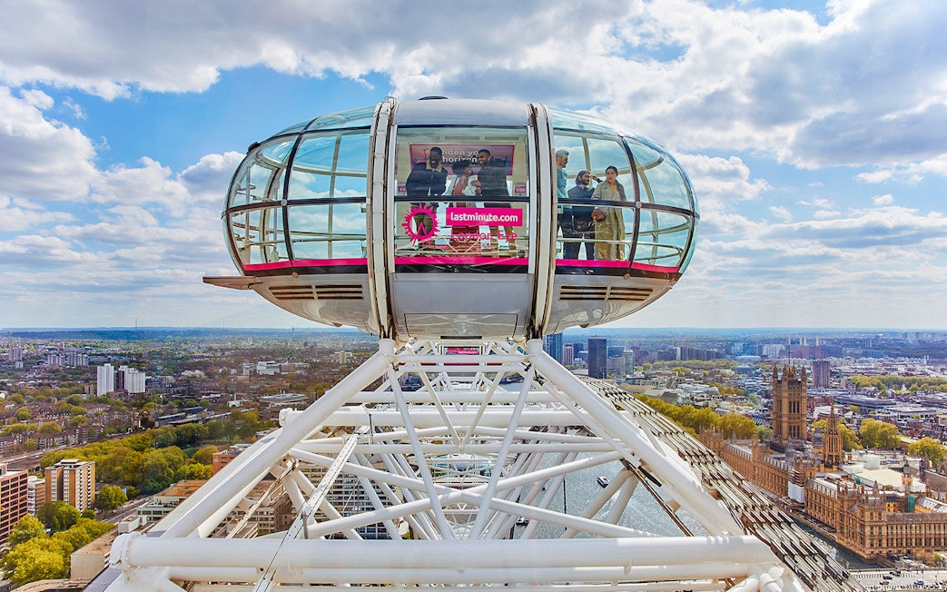 London Eye capsule overlooking Thames River and cityscape.