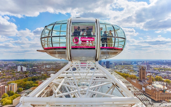 London Eye capsule overlooking Thames River and cityscape.