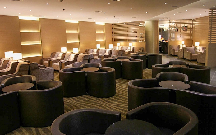 Plaza Premium Lounge seating area with modern chairs and ambient lighting.