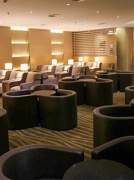 Plaza Premium Lounge seating area with modern chairs and ambient lighting.