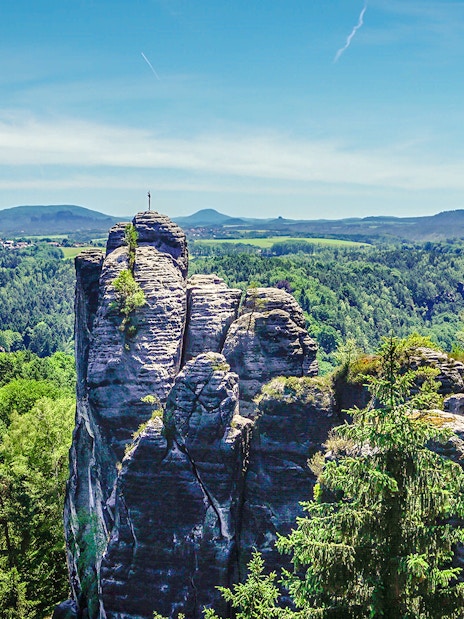 Rock formations and lush forest in Elbe Sandstone Mountains, Germany.