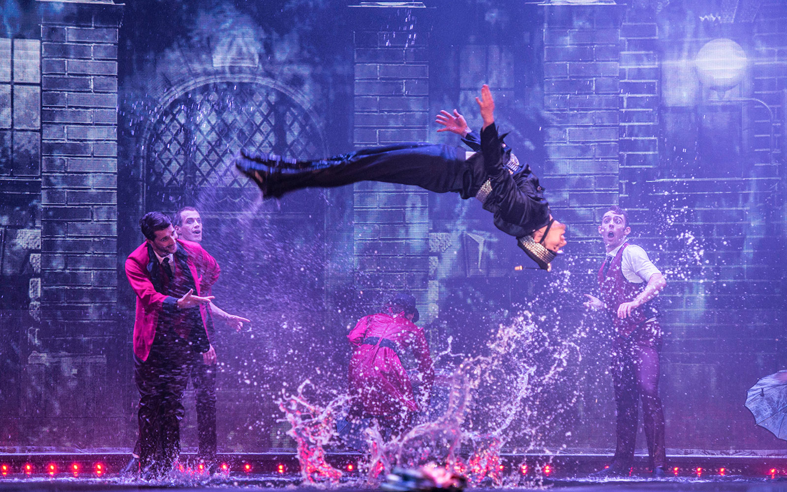 Performer mid-air during WOW: The Vegas Spectacular show with water effects.