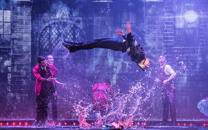Performer mid-air during WOW: The Vegas Spectacular show with water effects.