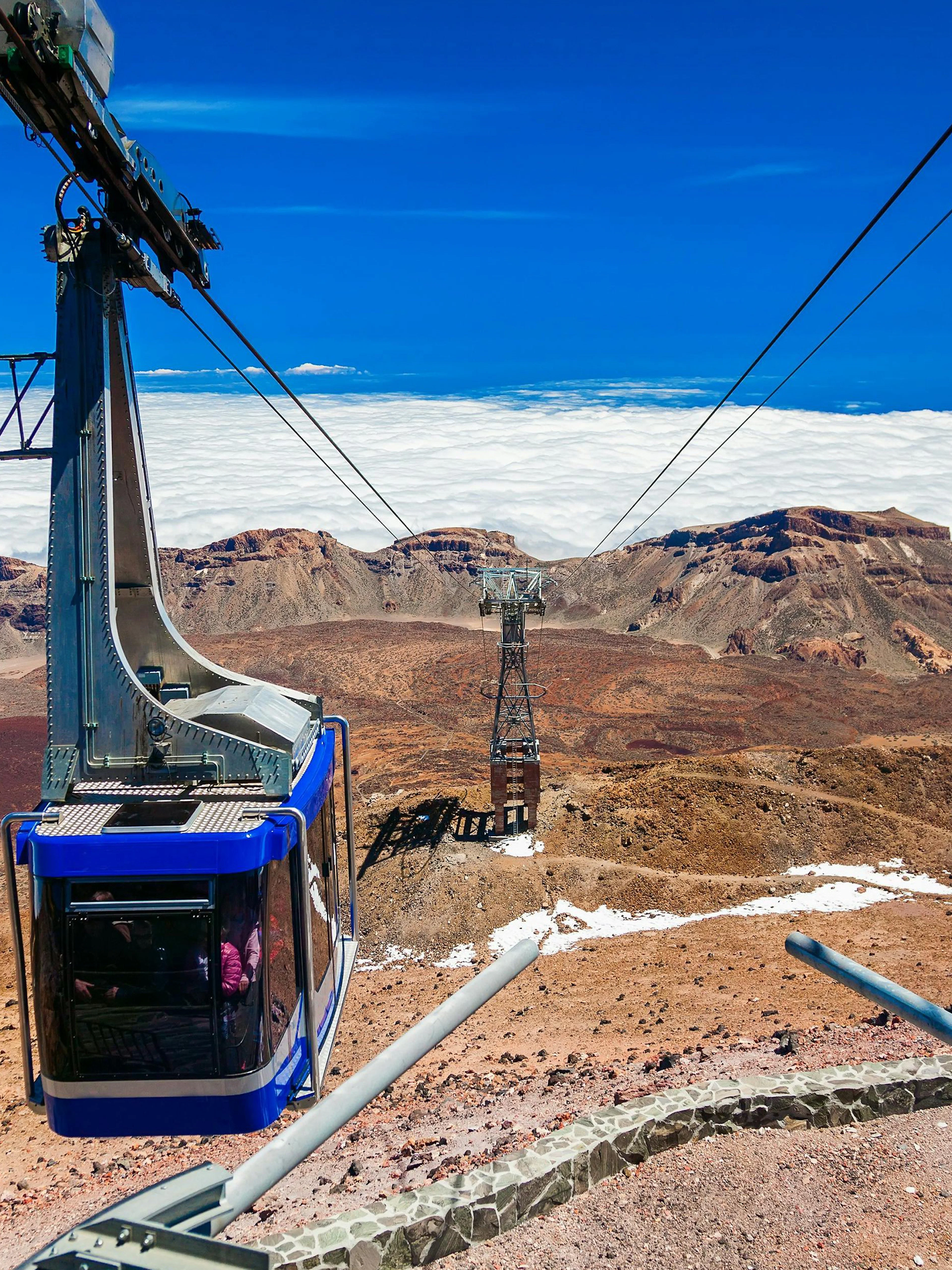 Cable car ascending Mount Teide with volcanic landscape in Tenerife.