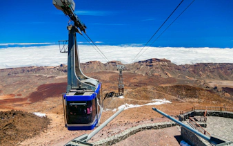 Cable car ascending Mount Teide with volcanic landscape in Tenerife.