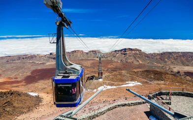 Cable car ascending Mount Teide with volcanic landscape in Tenerife.