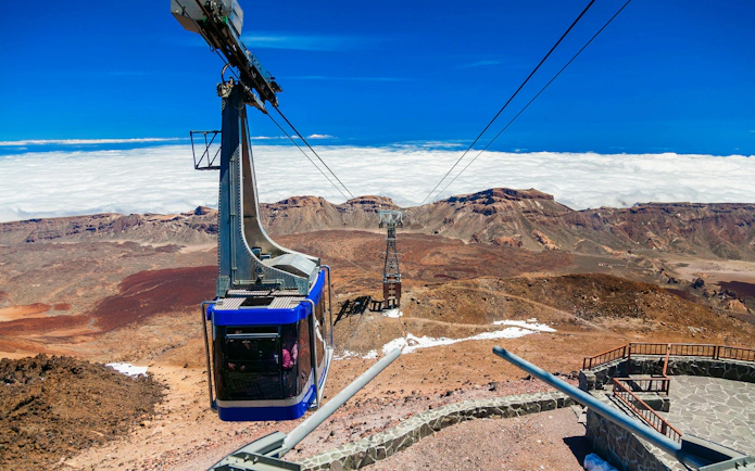Cable car ascending Mount Teide with volcanic landscape in Tenerife.