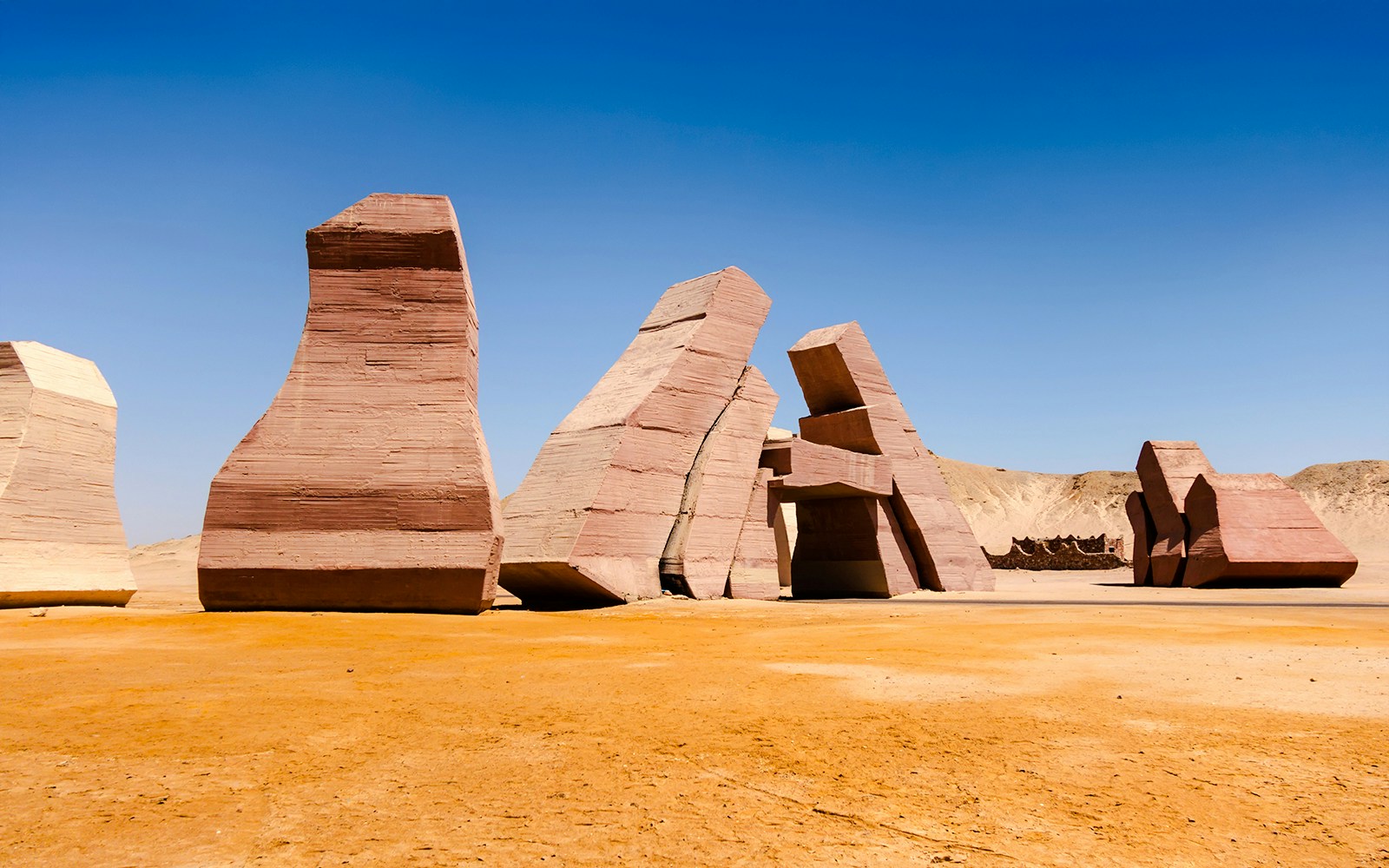 Entry gate sculptures at Ras Mohammed National Park, Egypt under clear blue sky.