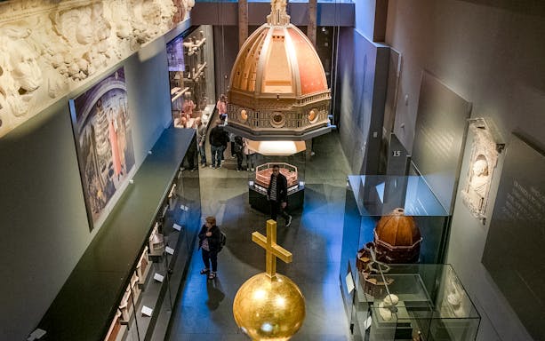 Florence Duomo Museum exhibits with dome model and sculptures.