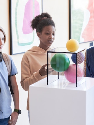 Visitors exploring marine life exhibits at Blue Planet Aquarium, Cheshire, UK.