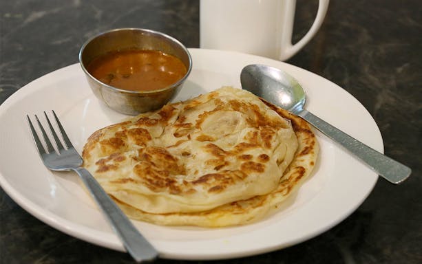 Plate with paratha and curry served on the Bike and Bites Food Tour.