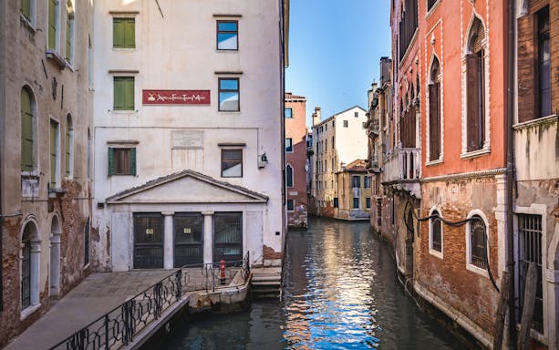 Venice canal view with historic buildings on a 2-hour walking tour.