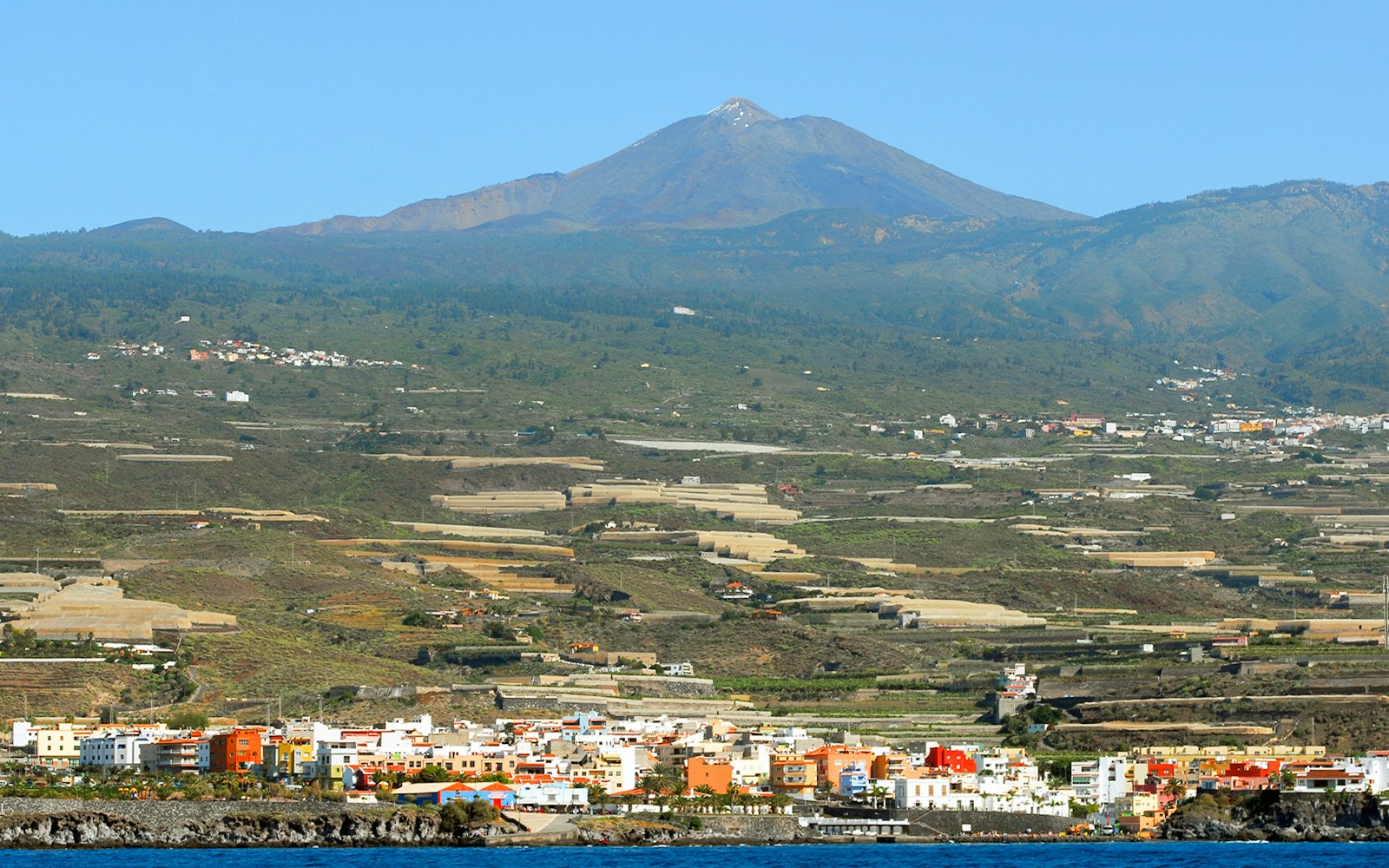 Teide volcano overlooking coastal town in Tenerife, Canary Islands.