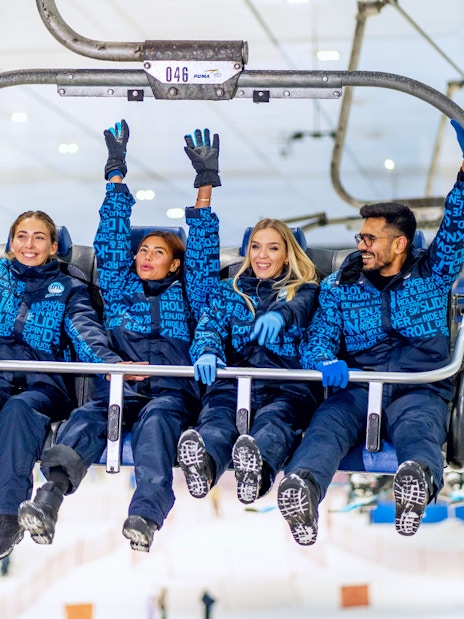 People enjoying a chairlift ride at Ski Dubai Snow Park.