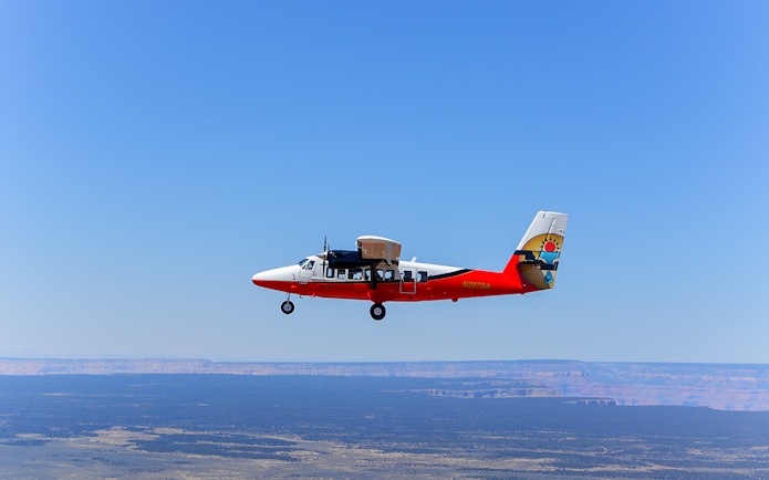 Airplane flying over desert landscape on Antelope Canyon tour from Las Vegas.
