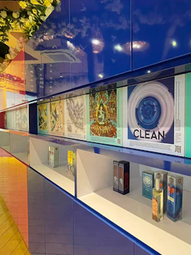 Perfume display at Scentopia Sentosa with colorful artwork and fragrance bottles.