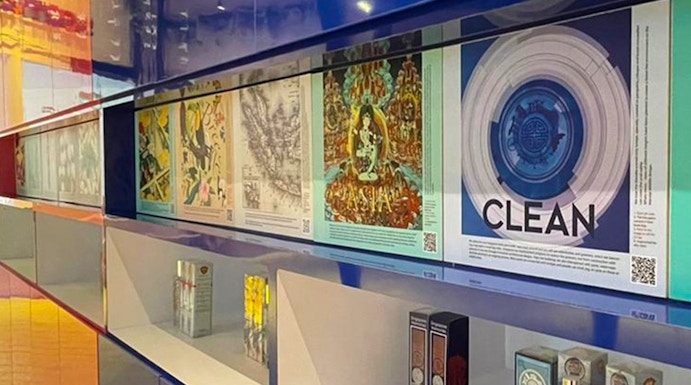 Perfume display at Scentopia Sentosa with colorful artwork and fragrance bottles.