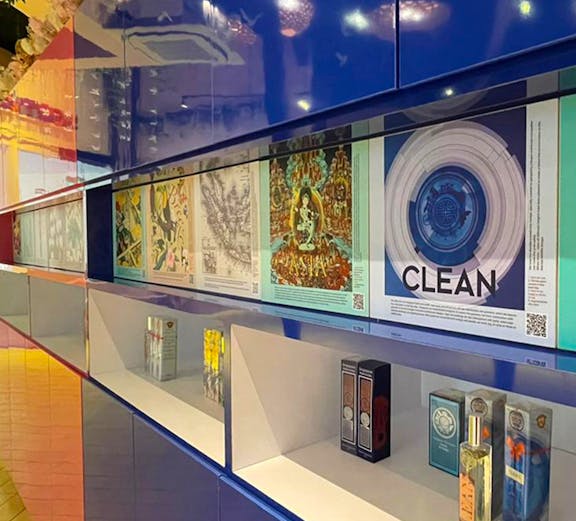 Perfume display at Scentopia Sentosa with colorful artwork and fragrance bottles.