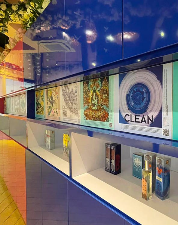 Perfume display at Scentopia Sentosa with colorful artwork and fragrance bottles.
