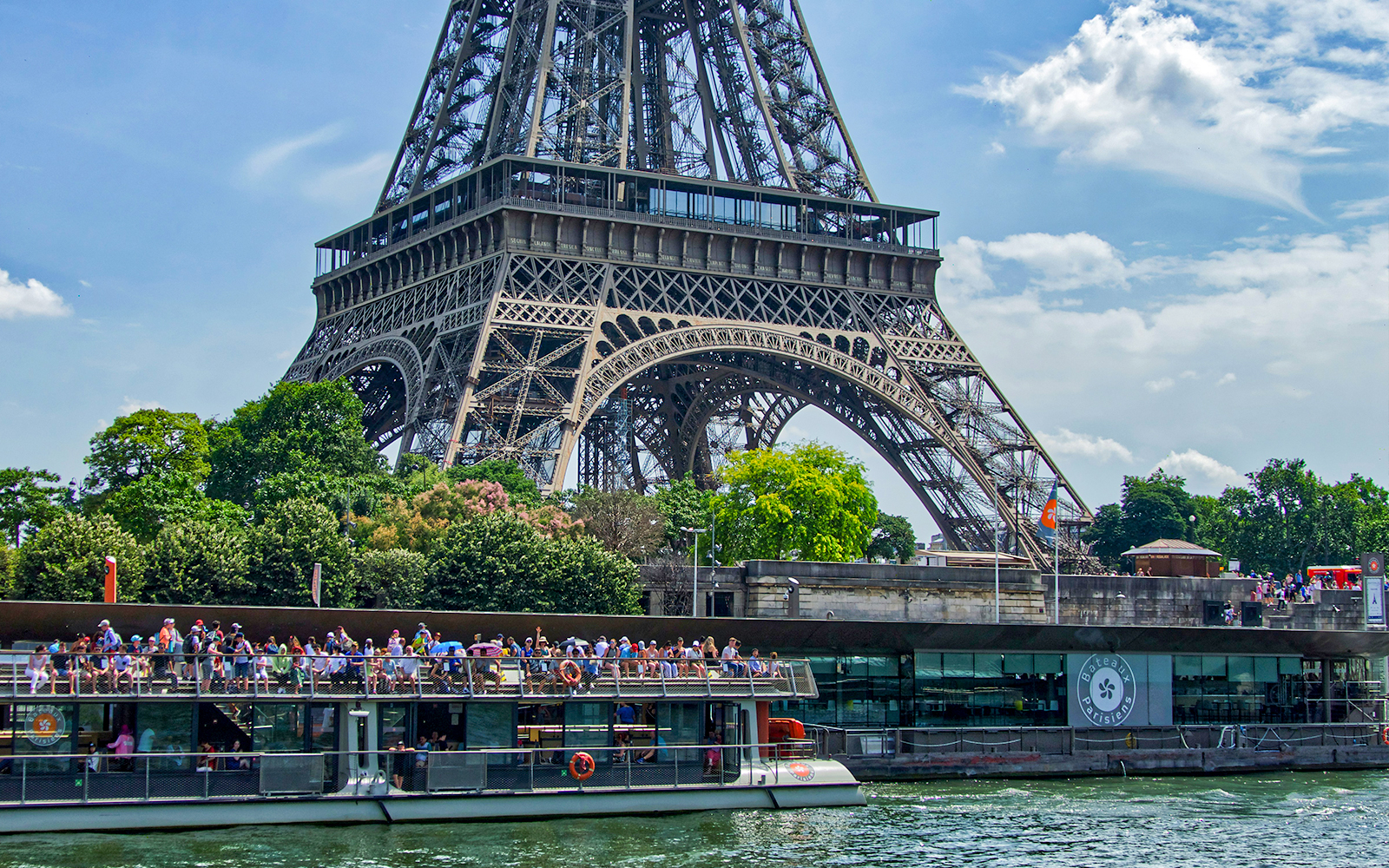 Port de la Bourdonnais with Bateaux Parisien cruise boats docked along the Seine River in Paris.