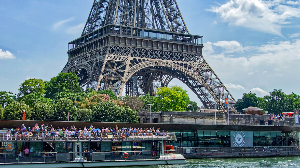 Port de la Bourdonnais with Bateaux Parisien cruise boats docked along the Seine River in Paris.