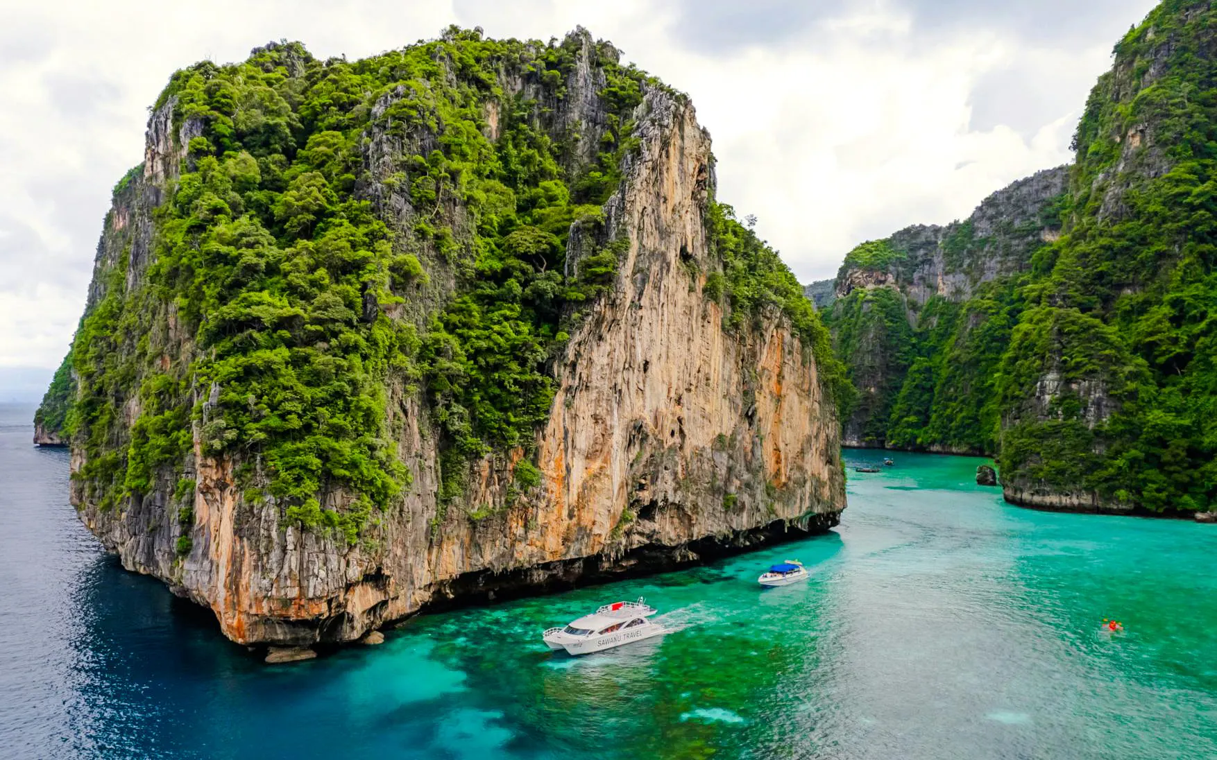 Catamaran sailing near limestone cliffs in Phi Phi Islands, Phuket.