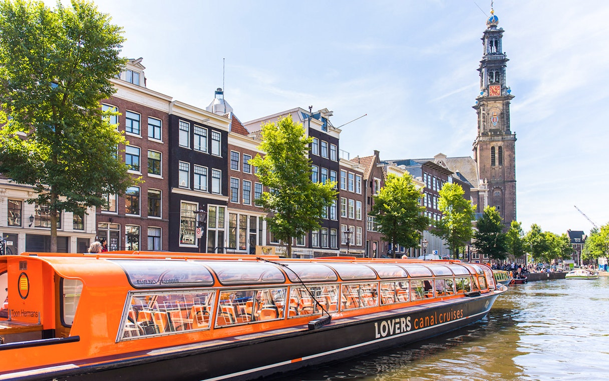 Hop-on hop-off canal boat near Westerkerk in Amsterdam.