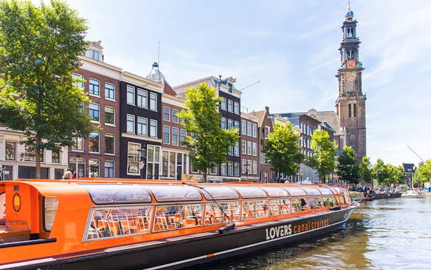 Hop-on hop-off canal boat near Westerkerk in Amsterdam.