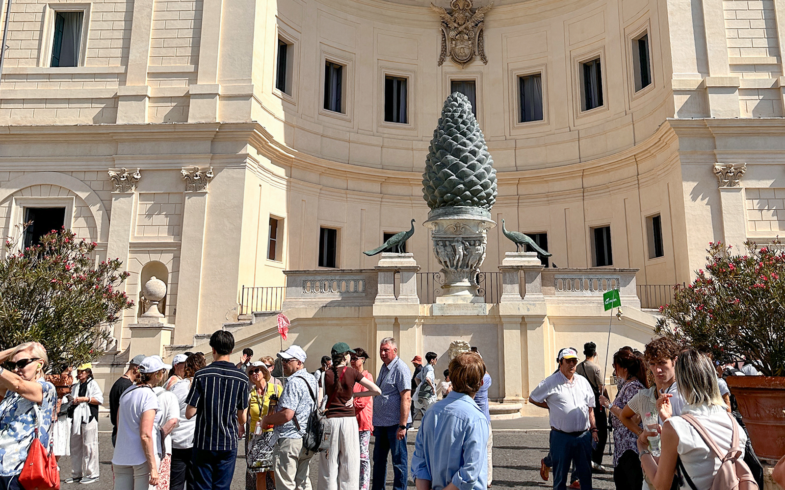 Visitors gather near the Pinecone Courtyard on a Vatican Museums guided tour.